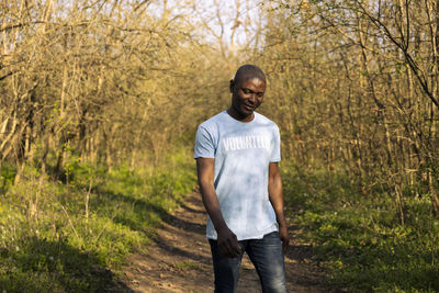 Portrait of young man standing on field