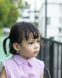 Close-up of cute girl looking away