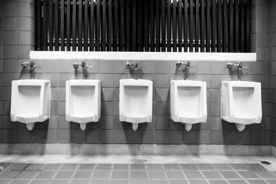 Row of objects on tiled floor