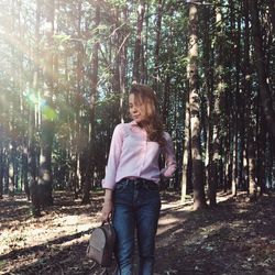 Woman standing in forest