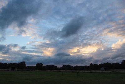 Scenic view of field against sky during sunset