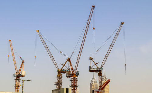 Big cranes at construction sites in the city of dubai in the united arab emirates