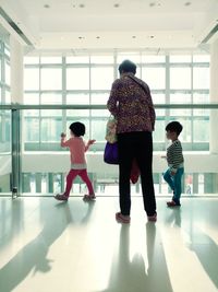 Rear view of two people in corridor