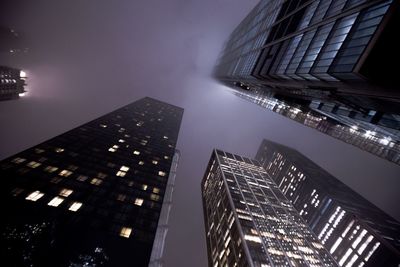 Low angle view of skyscrapers lit up at night