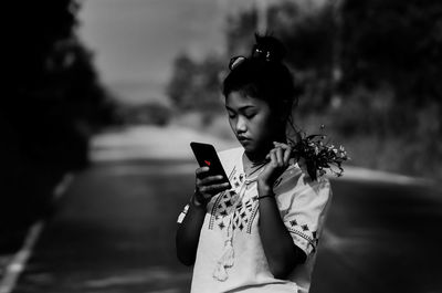 Woman using mobile phone outdoors