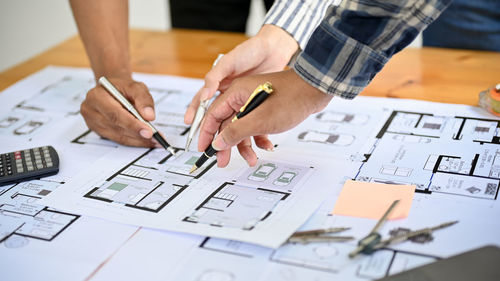 Midsection of man working on table