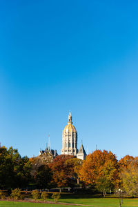 View of temple against clear blue sky