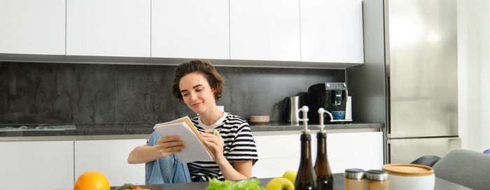 Portrait of young woman sitting at home