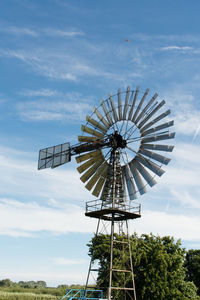 Low angle view of traditional windmill against sky