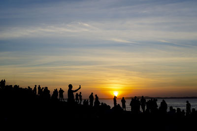 Silhouette people at sunset