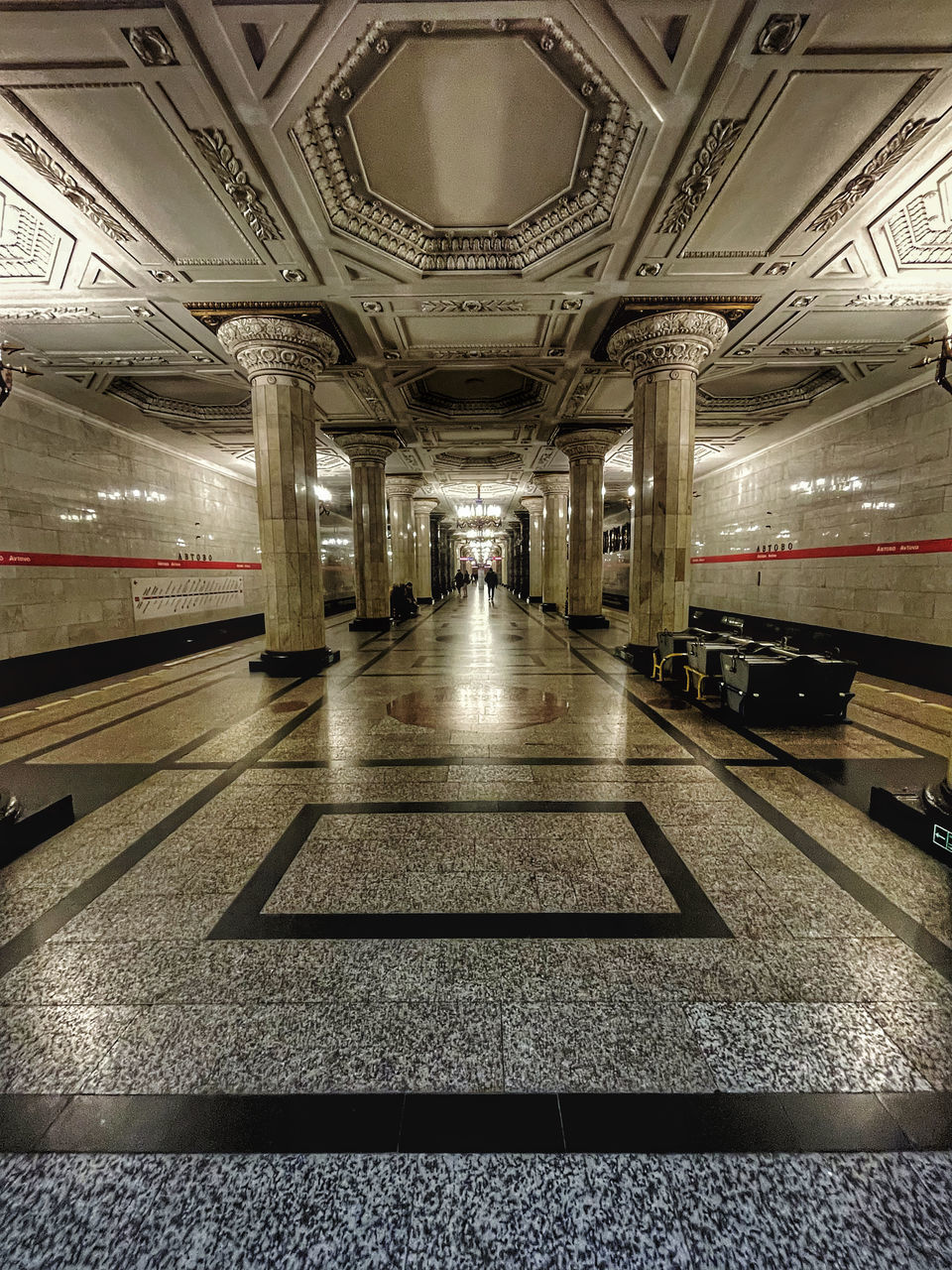 TRAIN AT ILLUMINATED RAILROAD STATION PLATFORM