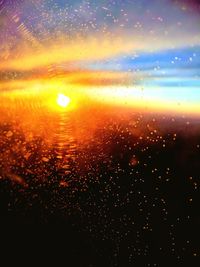 Close-up of wet sea against sky during sunset