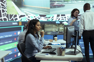 Young woman using mobile phone in office