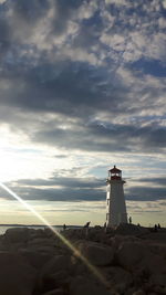 Low angle view of lighthouse against sky during sunset