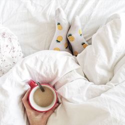 High angle view of coffee cup on bed