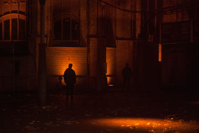 Silhouette man in temple at night