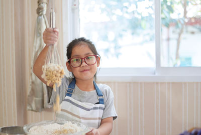 Portrait of smiling boy holding eyeglasses