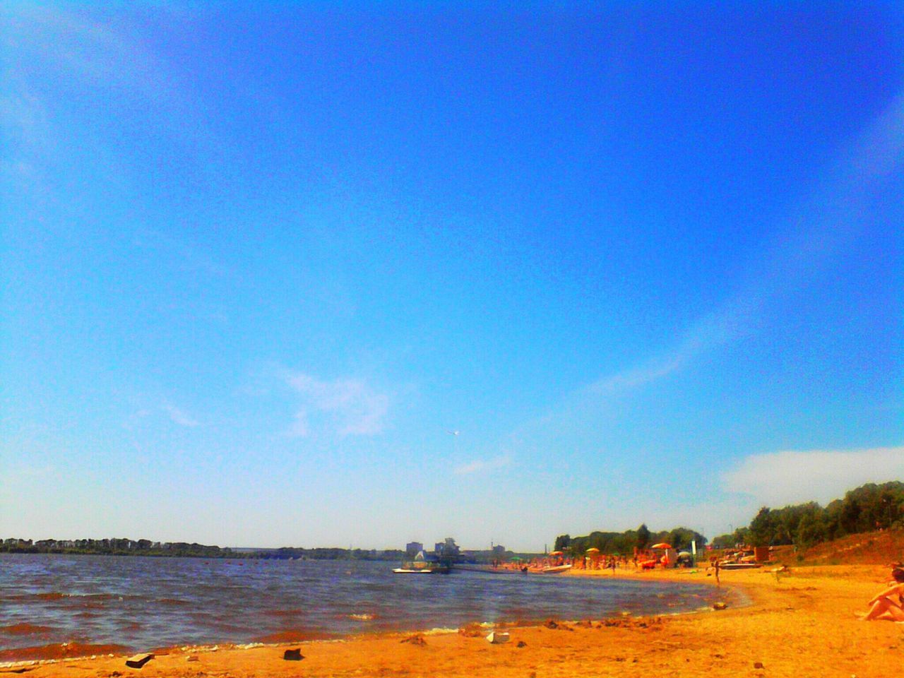 beach, water, blue, sand, sea, tranquil scene, tranquility, shore, scenics, beauty in nature, sky, nature, copy space, idyllic, incidental people, clear sky, horizon over water, coastline, non-urban scene, day