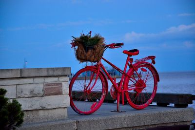 Red bicycle against sky