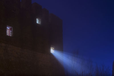 Light passing through fort window against blue sky