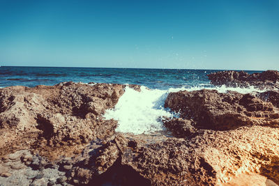 Scenic view of sea against clear blue sky