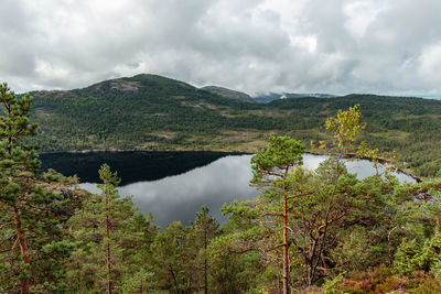 Scenic view of lake and mountains against sky