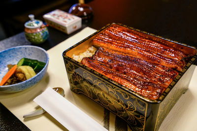 Broiled eel served over rice in a lacquered box