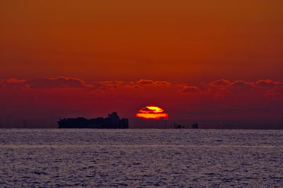 Scenic view of sea against romantic sky at sunrise