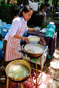 Rear view of people playing on street