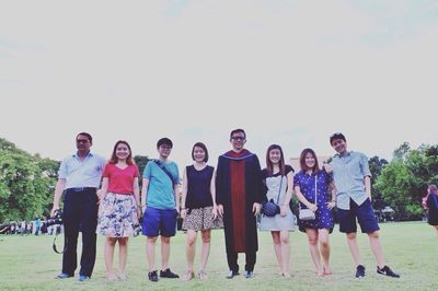 Friends standing on grass