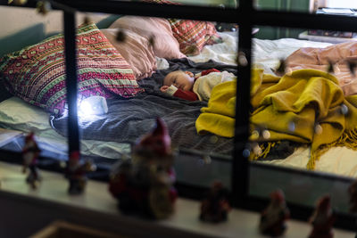 Boy sleeping on bed at home