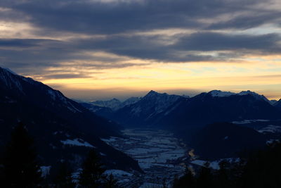 Scenic view of snowcapped mountains against sky during sunset