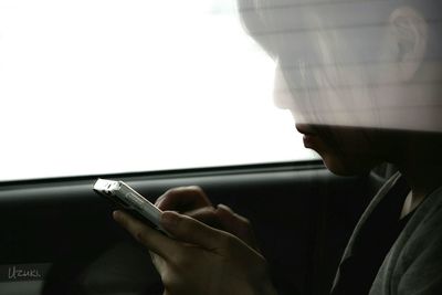 Cropped image of woman holding smart phone