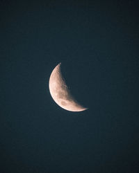 Low angle view of half moon against sky at night