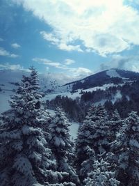 Scenic view of snow covered mountains against sky