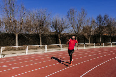 Full length of athlete running on sports track