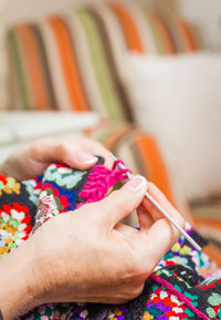 Midsection of woman holding multi colored baby