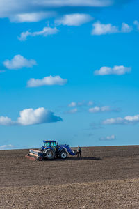 Farmer sowing with tractor