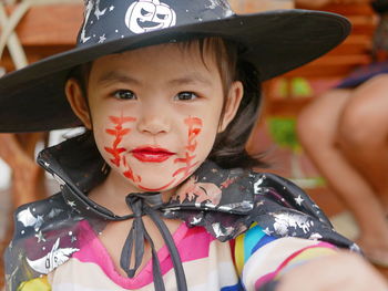 Close-up portrait of cute girl wearing hat