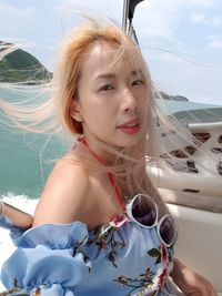 Portrait of beautiful woman traveling in yacht