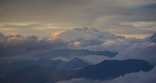 Scenic view of majestic mountains against sky during sunset