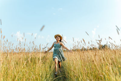 Full length of child standing on field against sky