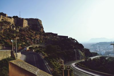 Road by mountain against clear sky