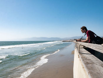 Scenic view of beach against clear blue sky