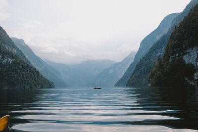 Scenic view of sea and mountains against sky