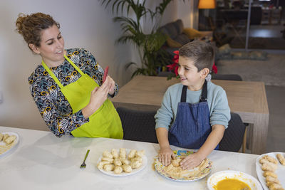 Mother and son making croquettes in the kitchen