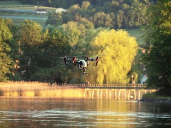 Quadcopter drone flying over river