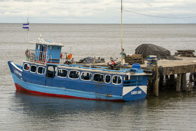 Boat moored on sea against sky