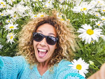 Portrait of smiling young woman wearing sunglasses