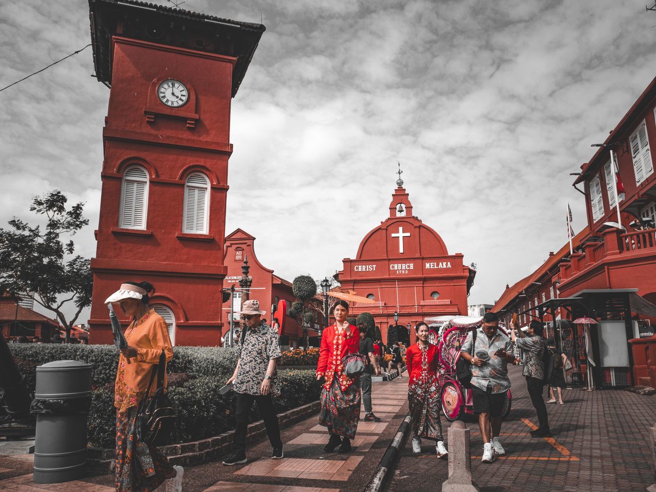 clock, architecture, building exterior, built structure, city, tower, sky, travel destinations, building, clock tower, cloud, nature, religion, town, street, group of people, history, place of worship, travel, time, the past, belief, landmark, red, tourism, wall clock, temple, outdoors, adult, person, men, spirituality, transportation